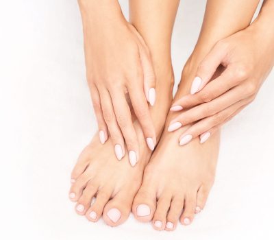 Beautiful salon procedure with pink pedicure on towel background. For decoration design. Healthcare. Woman body care. Spa treatment. White background. Nail polish. Apricot stick prepare